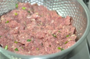 Home made Beef Burger - add ingredients to mince and mix