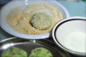 aloo tikki burger - dip in bread crumbs