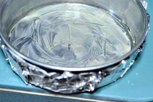 grease baking tin and cover with fim