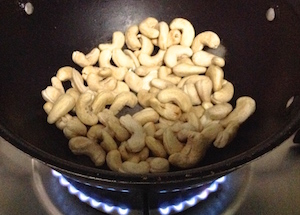 add raw cashews to pan