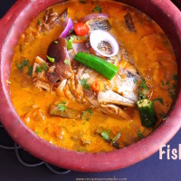 Singapore fish head curry in a clay pot