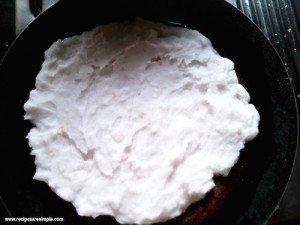 rice flour roti spread on tawa pan